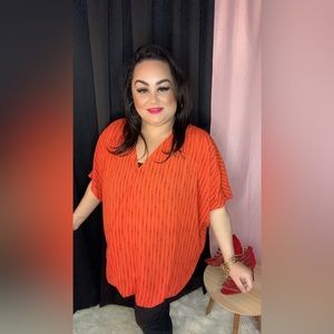 Orange and black top perfect fit my plus size divas. Size 3x.